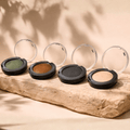 Premium Mood Bild der Naturkosmetik Lidschatten in vier Farbtönen auf Naturstein